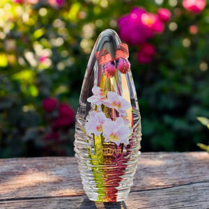 Glass design urn with yellow-pink ash chamber and image of orchids with space for a short name – suitable for cremation ashes.