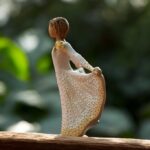 Willow Tree figurine Butterfly girl with wide butterfly dress and golden accents holding mini urn for ashes or a lock of hair