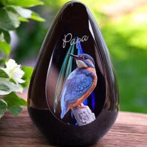 Design urn made of glass with purple-pink ash chamber and subtle pattern of air bubbles above the ash chamber – for cremation ashes.