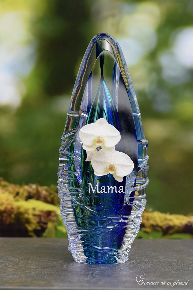 Design urn made of glass with transparent green-yellow ash chamber and image of white freesias – suitable for cremation ashes.