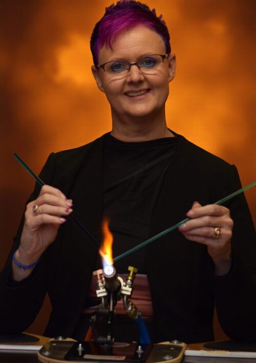 jet couwenberg in her atelier with a burner a glass