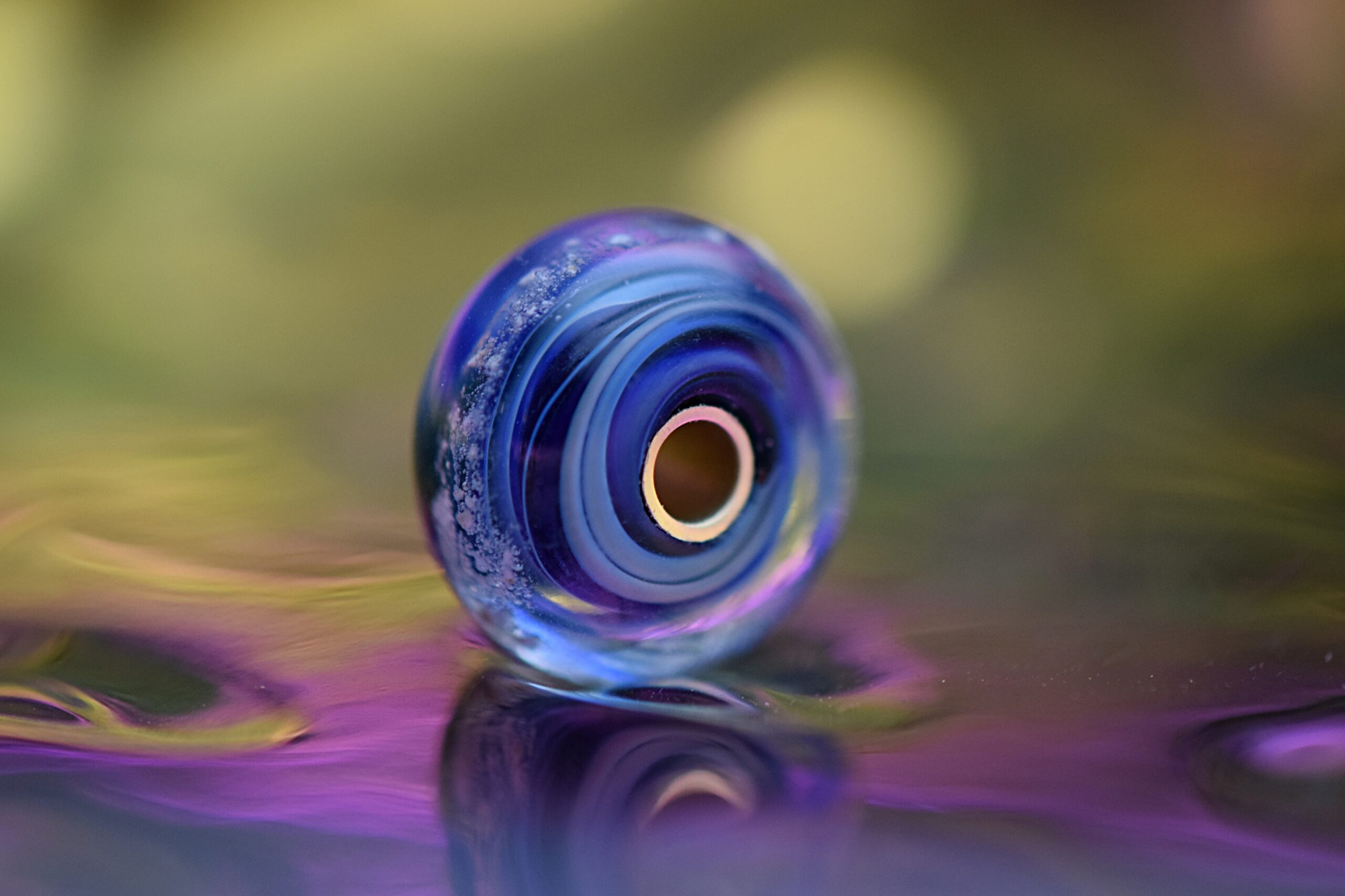 a blue glass bead with cremation ashes