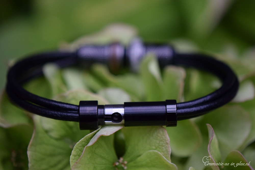 Memorial bracelet made of smooth black leather with silver steel design beads and two keepsakes.