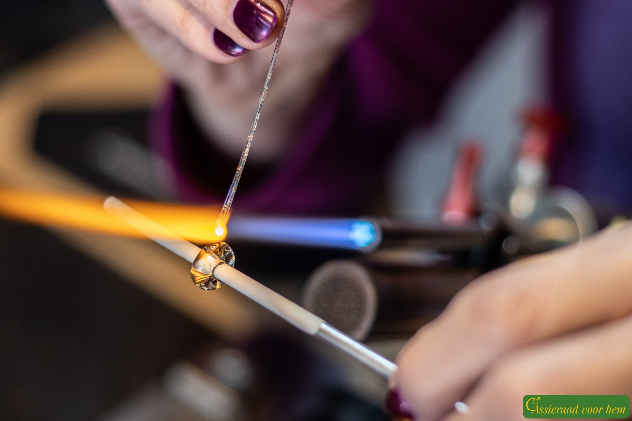 Back view of black sailrope bracelet with transparent blue cremation ashes glass bead and silver anchor compass clasp.