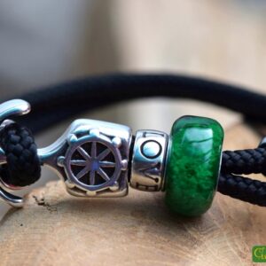 Men’s memorial bracelet in black sailrope with transparent green glass bead containing cremation ashes.