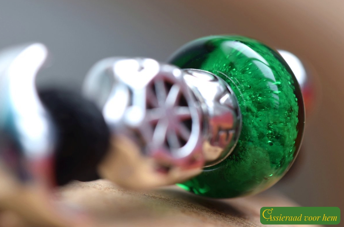Back view of black men’s memorial bracelet with transparent green cremation ashes glass bead.