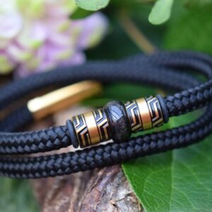 Front view of black sailrope men’s memorial bracelet with ashes in central gold stainless-steel bead.