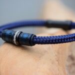 Side view of blue sailrope men’s memorial bracelet with ashes in black stainless-steel bead.