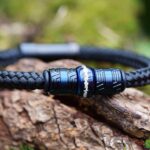 Front view of black sailrope men’s memorial bracelet with ashes in central stainless-steel bead.