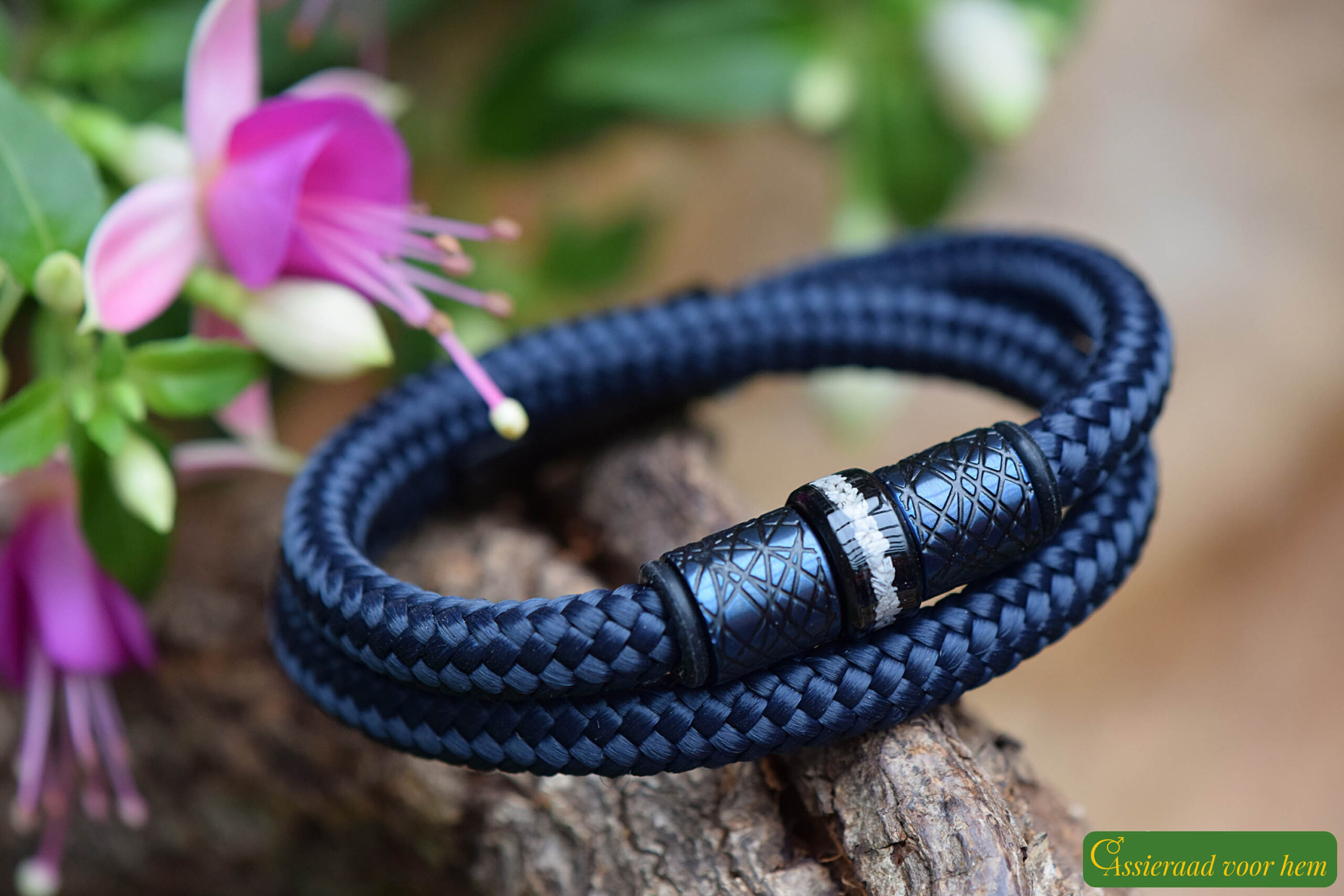 Detail of stainless-steel ashes bead between blue and black design beads on men’s memorial bracelet.