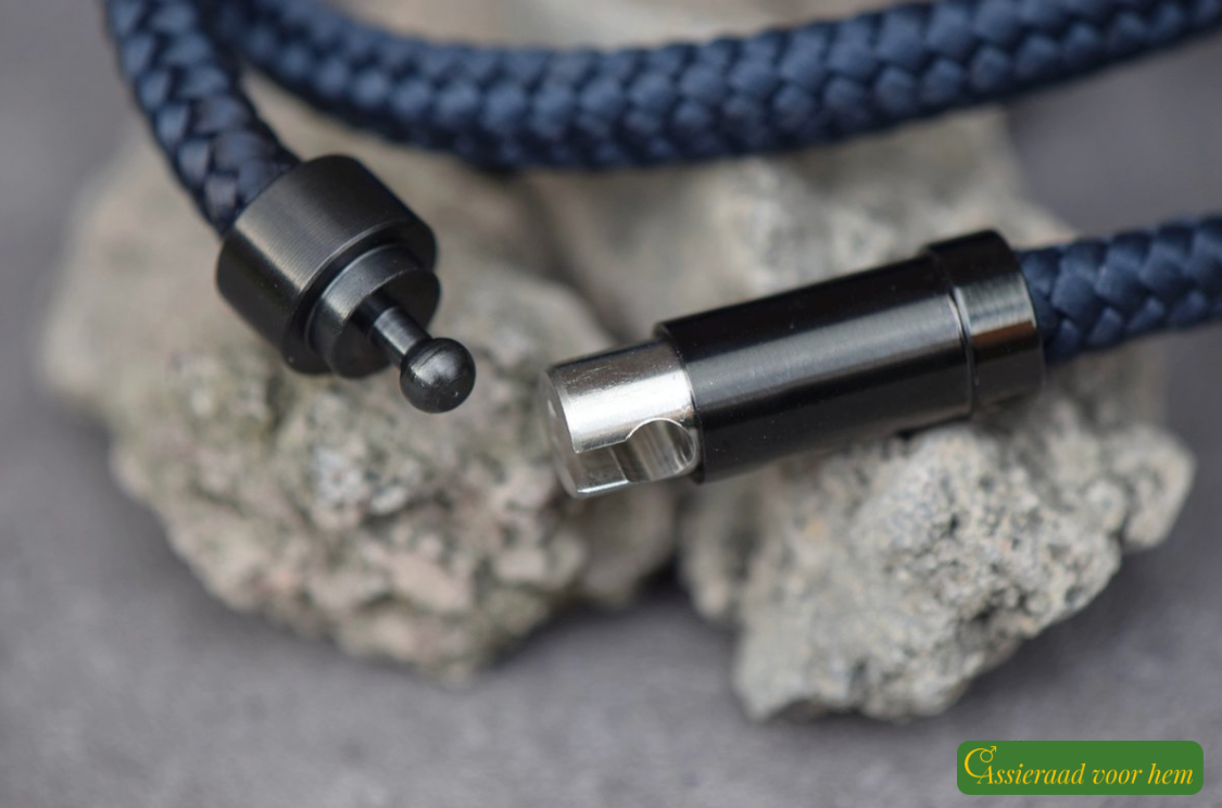 Close-up of secure black stainless-steel slide clasp on blue memorial bracelet.