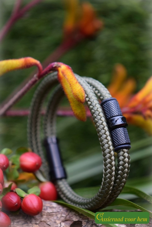 Double olive sailrope bracelet with cremation ashes bead between black metallic design beads.