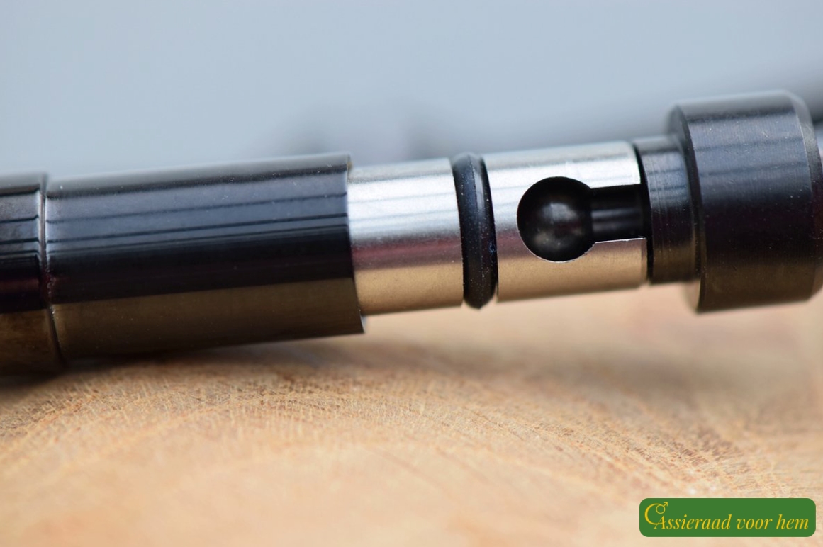 Detail of black stainless-steel cup-and-cone slide clasp with spring system on men’s bracelet.