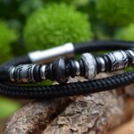Black double sailrope bracelet with silver-tone design beads and two stainless-steel beads containing ashes.