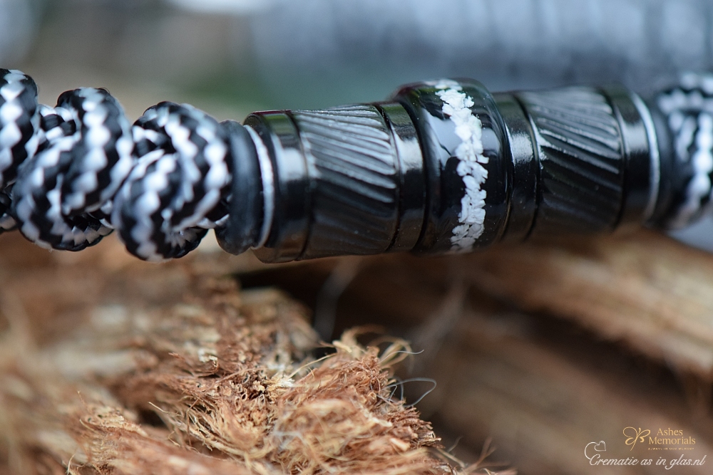 centre stainless steel bead containing cremation ashes.