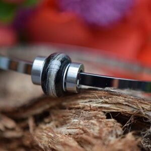 Women’s memorial bracelet with lock of hair in black stainless steel bead on stainless steel bangle.