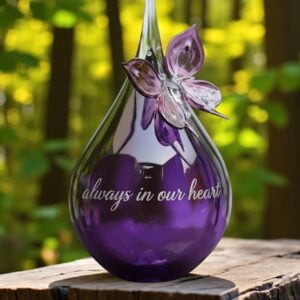 Medium glass urn with butterfly in transparent purple glass for cremation ashes.