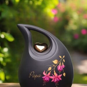 Black ceramic memorial urn 2.2 liter with golden heart, pink fuchsia flower and personalized gold foil name.