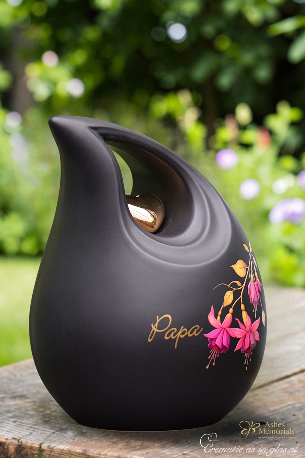 Side view of matte black ceramic memorial urn in large teardrop shape with golden heart detail.